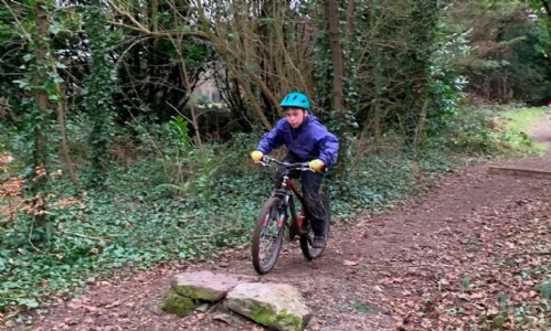 Year 7 student cycling on dirt path